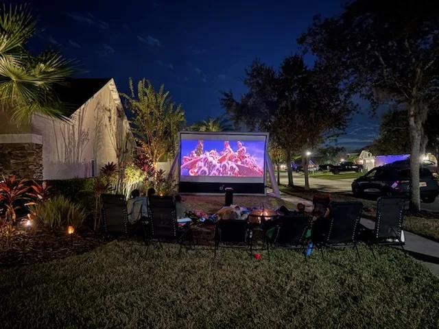 Outdoor movie night with guests enjoying the show
